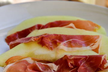 traditional Italian appetizer of prosciutto and melon. selective focus and copy space