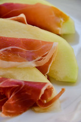  traditional Italian appetizer of prosciutto and melon. selective focus and copy space