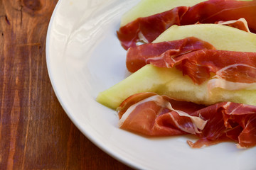 traditional Italian appetizer of prosciutto and melon. selective focus and copy space
