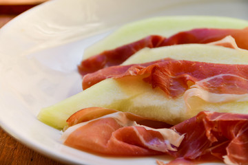  traditional Italian appetizer of prosciutto and melon. selective focus and copy space