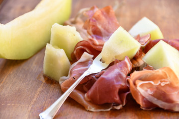 traditional Italian appetizer of prosciutto and melon. selective focus and copy space
