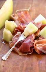 traditional Italian appetizer of prosciutto and melon. selective focus and copy space