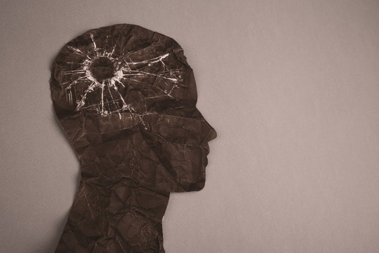 Brain disorder symbol presented by human head made form paper . Creative idea for Alzheimer's disease, dementia, memory loss and mental health concept.