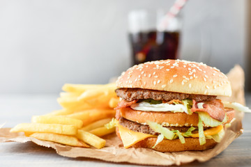 double cheeseburger with fries. takeaway lunch, fast food restaurant, fast food menu. light background, selective focus and copy space
