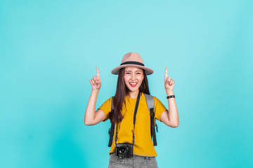 Portrait Asian woman traveler with cheerful feeling over blue background with copy space for summer travelling concept