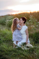 Happy loving family. Mother and her daughter child girl playing and hugging