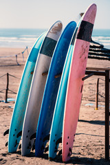 Different colors of surf on a the sandy beach in Casablanca - Morocco. Beautiful view on sandy beach and ocean. Surf boards for renting. Surfer school. - 251047449