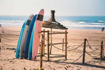 Different colors of surf on a the sandy beach in Casablanca - Morocco. Beautiful view on sandy beach and ocean. Surf boards for renting. Surfer school. - 251047492