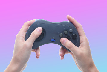 Hands holding gamepad isolated on neon background. © splitov27