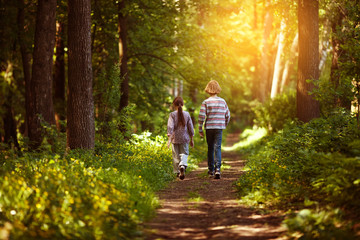 Fototapeta na wymiar Two children are walking along the path