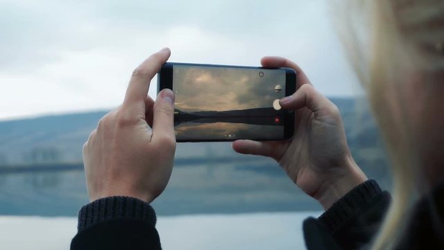 Woman taking picture with smartphone