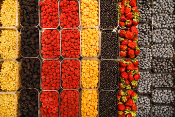 Colourful mix of different fresh berries at market