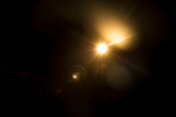 Abstract Natural Sun flare on the black background.