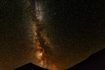 A bright starry night with millions of stars and a galaxy Milky way from the altitude of the...