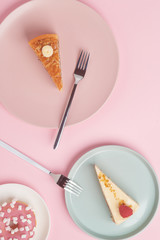 A piece of cake, cheesecake on a plate with a fork on a pink background.