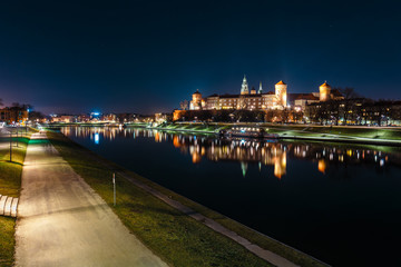 Fototapeta na wymiar The Royal Wawel Castle as seen from another bank of Vistula. Krakow is the most famous landmark in Poland. Night view