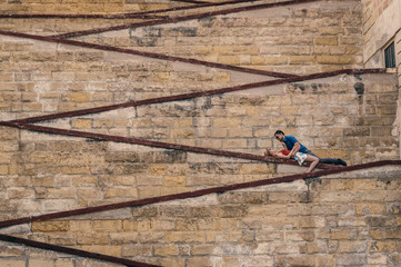 Man and woman laying on the city walls