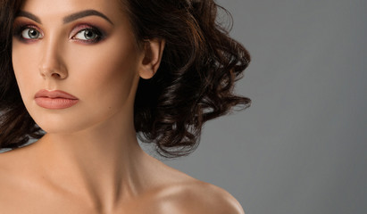 Fototapeta premium Model with long eyelashes and plump lips posing in studio.