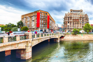 Fototapeta premium Antique building view in Old Town Bucharest city - capital of Romania and Dambrovita river