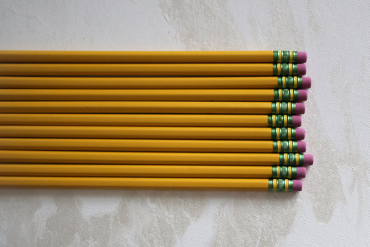 Back to School Concept Yellow Number 2 Pencils on a White Backdrop with Copy Space