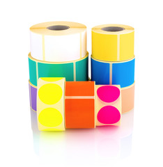 Colored label rolls isolated on white background with shadow reflection. Color reels of labels for...