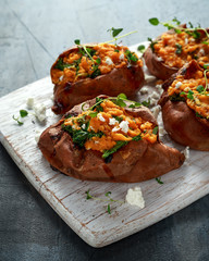 Roast sweet potato stuffed with feta cheese and kale. healthy food