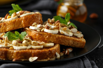 French cinnamon toast with banana, nuts and hazelnut, honey.