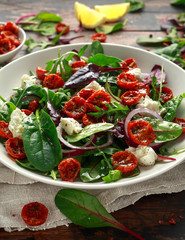 Sun dried tomatoes Salad with fresh vegetables mix and mozzarella cheese. healthy food