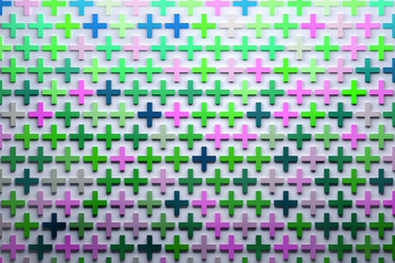Abstract pattern with many random colored pink green blue crosses or pus signs on white background. 3d illustration.