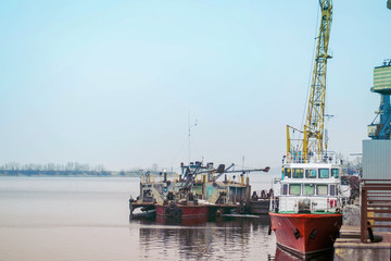 Cargo dock ship-lifting cranes in the harbor, Cargo river port terminal container