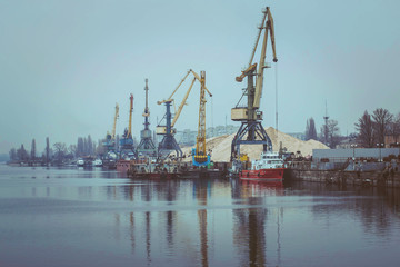 Obraz premium Cargo dock ship-lifting cranes in the harbor, Cargo river port terminal container