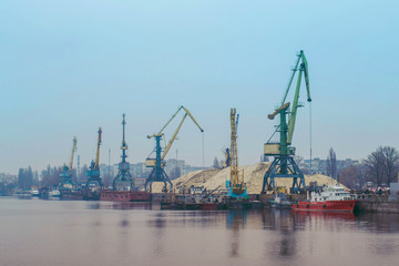 Cargo dock ship-lifting cranes in the harbor, Cargo river port terminal container