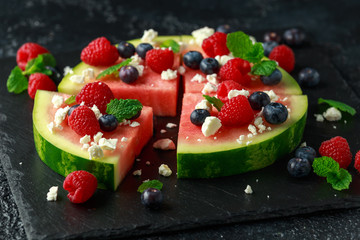 Juicy watermelon pizza with blueberries, raspberry feta cheese, mint. party food