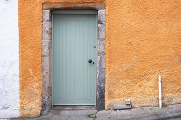 Orange old wooden door rustic ancient house entrance in Culross