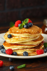 Homemade american blueberry, raspberries pancakes. Healthy morning breakfast. rustic style.