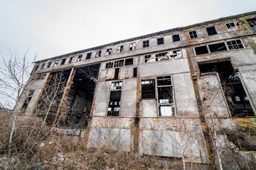 Abandoned ruined industrial factory building, ruins and demolition concept.