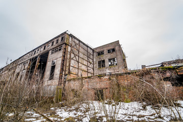 Fototapeta na wymiar Destroyed abandoned factory after the war, broken glass, destruction, frightening industrial composition