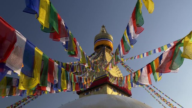 Colorful flags with Buddhist scriptures on a stupa in Nepal. UHD 4K