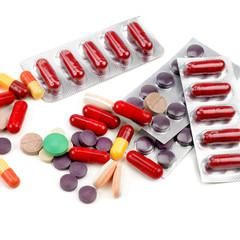 Assorted pharmaceutical medicine pills, tablets and capsules isolated on white background.