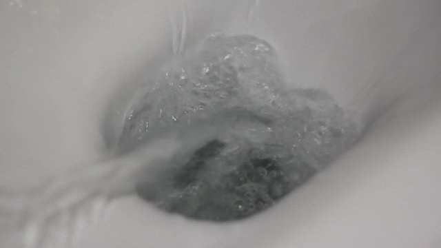 Flush the toilet. Close-up view