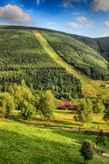 Obraz premium Valley in czech national park Giant mountain- Krkonose. The town with a lot of wooden huts in Spindleruv Mlyn. Czech nature is beautiful.