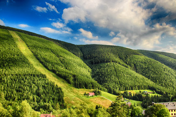 Obraz premium Valley in czech national park Giant mountain- Krkonose. The town with a lot of wooden huts in Spindleruv Mlyn. Czech nature is beautiful.
