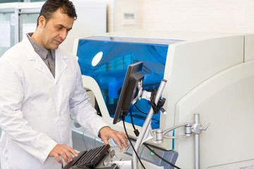 Mature Hispanic scientist working at his laboratory