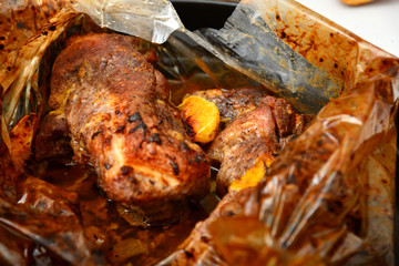 Fried juicy barbecue meat baked in the oven on a baking sheet.