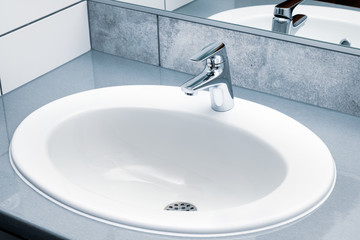 Fototapeta premium Sink and modern chrome faucet in public toilet