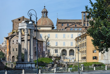 Obraz premium The base of the temple is Bellona, the ancient Roman goddess of war. Near three columns and the church of San Nicola in Carcher. Rome