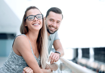 close up.smiling couple standing in the lobby of a modern hotel