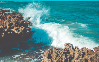 Sea waves hitting rocks on the beach. Big waves in the sea - blue water