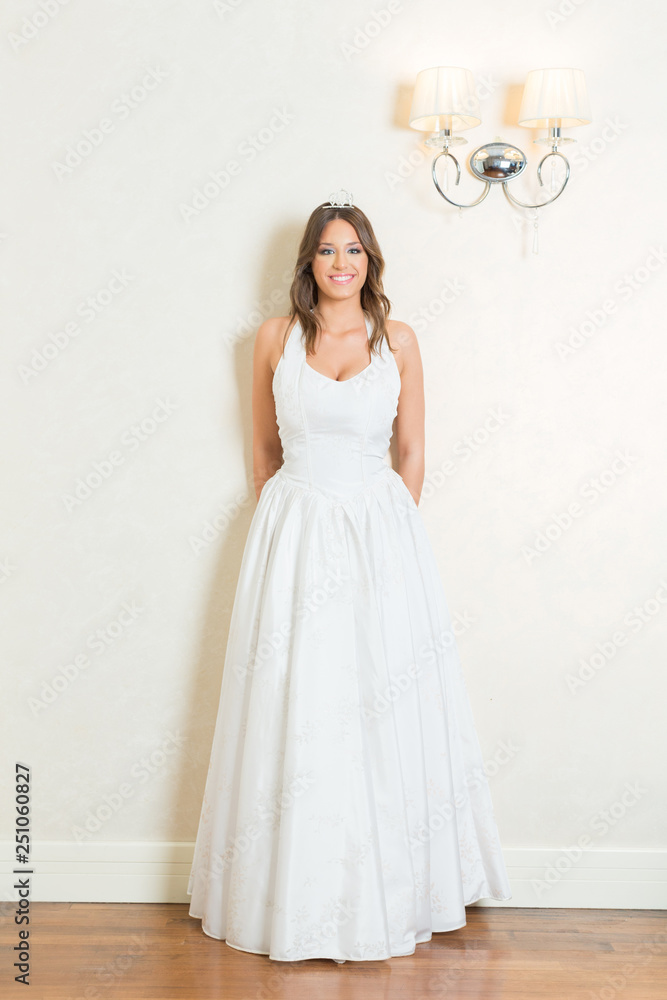 Wall mural beautiful young bride in white wedding dress