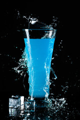 blue cocktail in glass and splash
